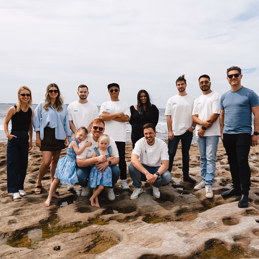 Jiffi team standing on a beach.